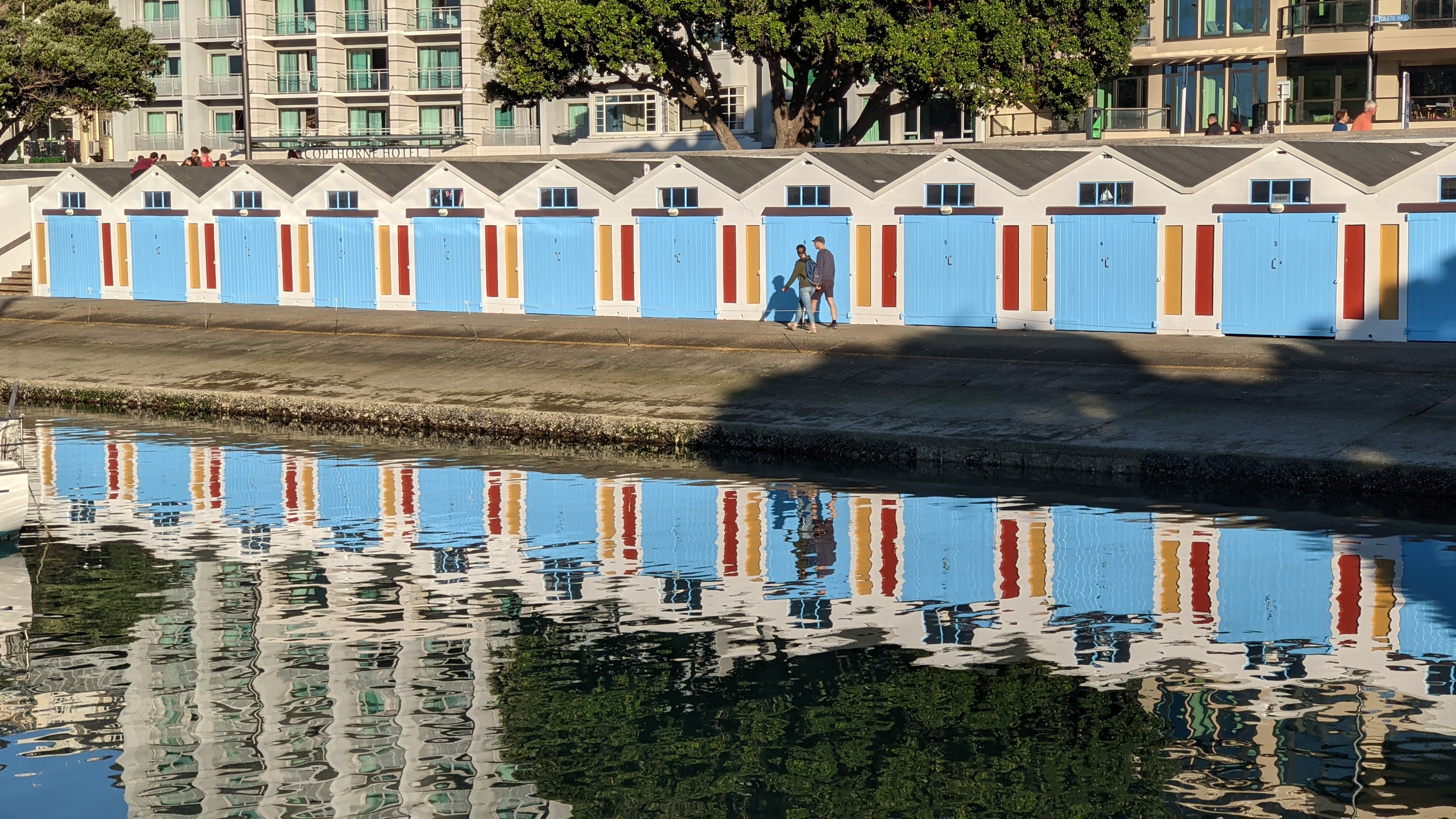 The boat sheds at Clyde Quay Boat Harbour reflecting in the water