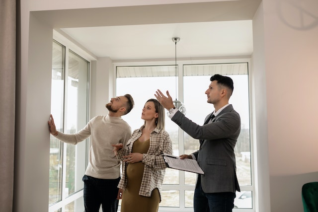 A realtor showing a home to first-time buyers