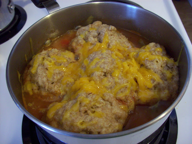 Cheese Dumplings simmering in pot of Tomato Stew.