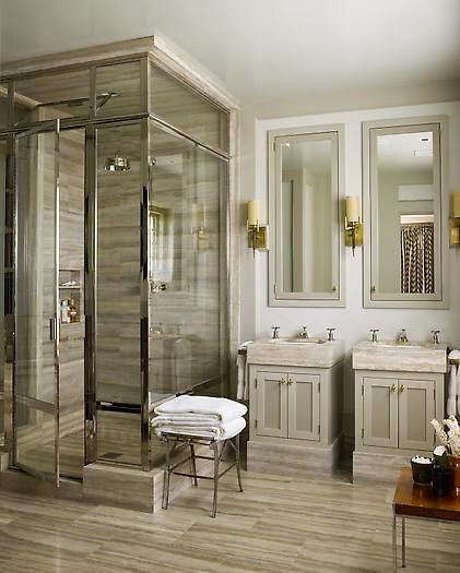 sleek bathroom with striated wood look tile floors glass polished shower enclosure