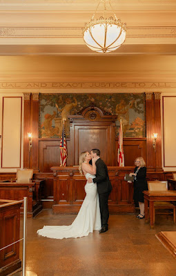 bride and groom first kiss courthouse ceremony