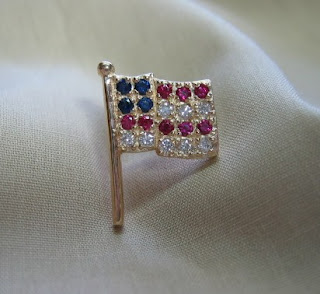 Unique custom designed gold US flag pin with genuine rubies, sapphires and diamonds