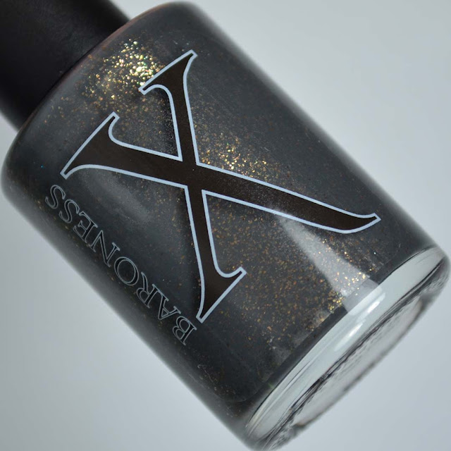 grey nail polish with bronze flecks in a bottle