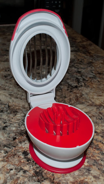 An open view of a strawberry slicer showing the tines.