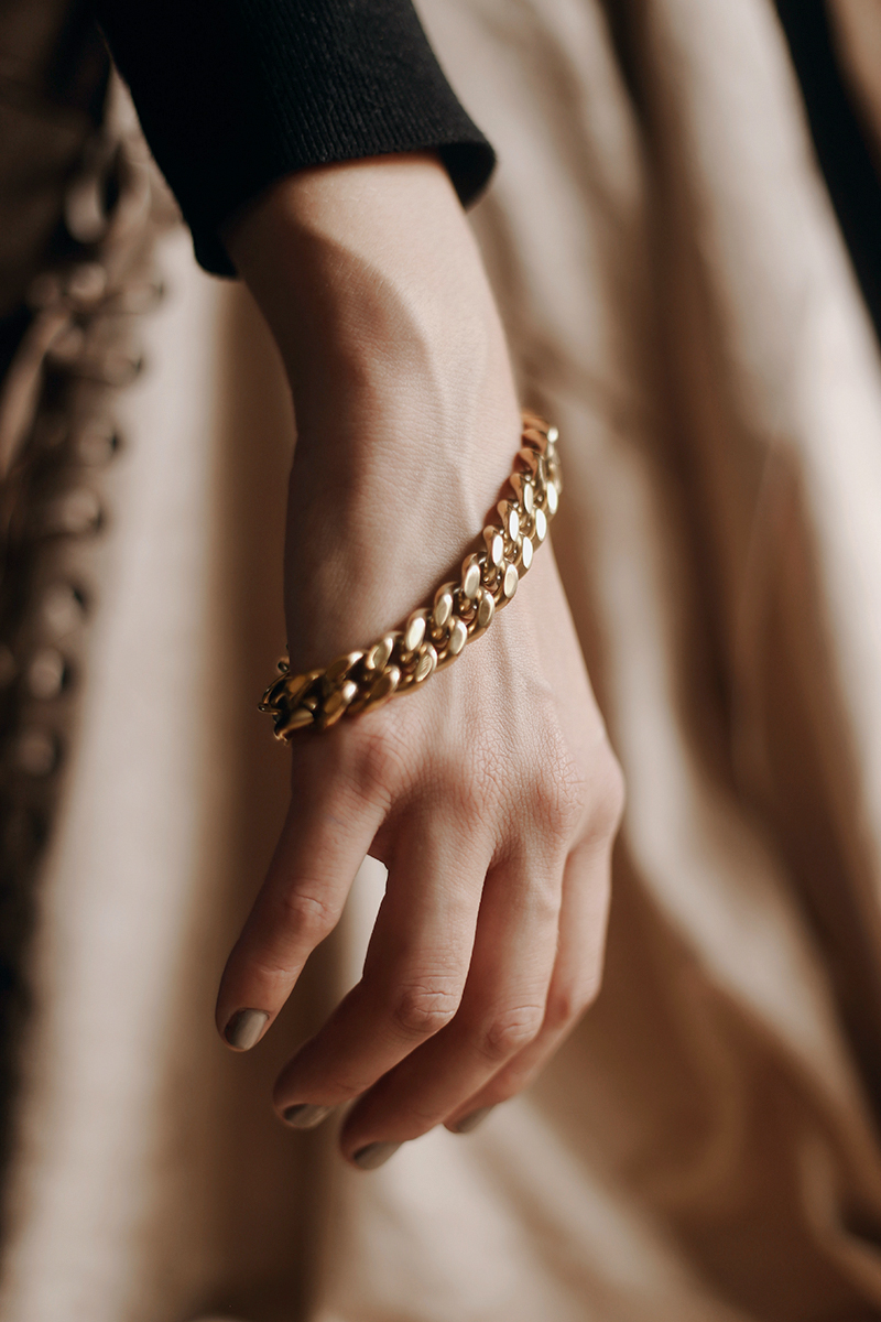 close-up of woman's hand with a thick chain bracelet