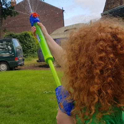 boy firing the Bunch O Balloons Soaker/Filler as a water gun blaster 