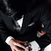 Close up of gentleman in suit checking watch