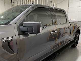 A gray Ford F-150 with car window tinting in Livonia