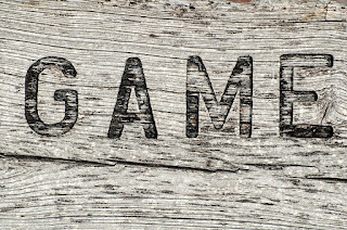 Wooden sign with the word Game