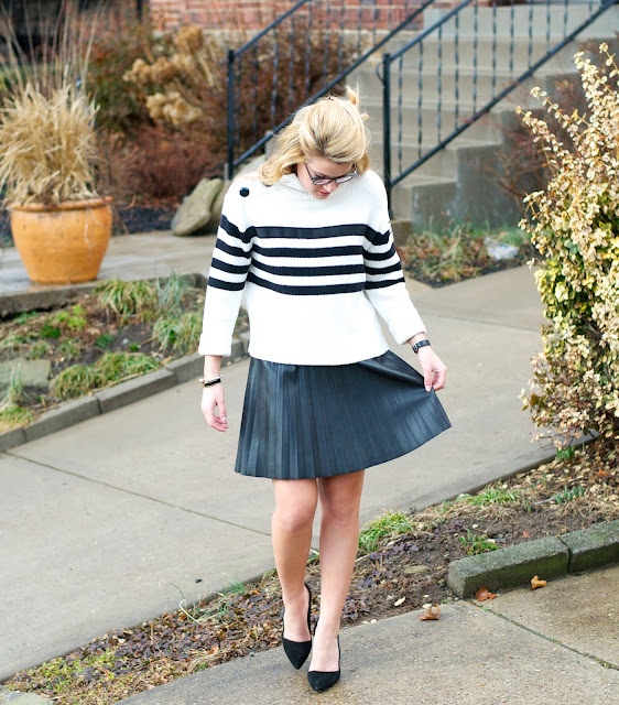 striped cotton sweater and faux leather skirt with black pumps