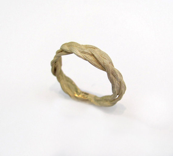  why not go with this 18kt gold braid ring for your wedding band