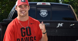 Caroline Ostman's husband Jake Fromm posing for a picture with the car