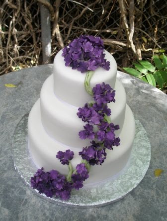 Square Three Tier Purple Wedding Cake With Cute White Flowers 