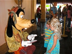 goofy signing a disney memory book