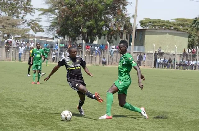 A midfield player dribbling an opponent on a Kenyan football pitch