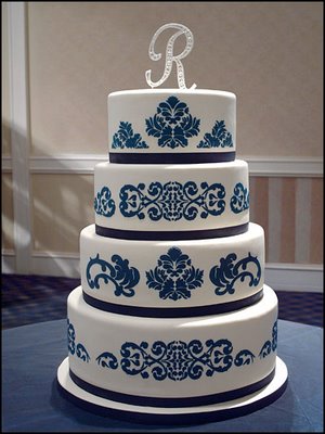 Elegant five tier square wedding cake with light blue icing base and dark