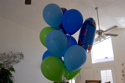 blue birthday balloons touching the ceiling