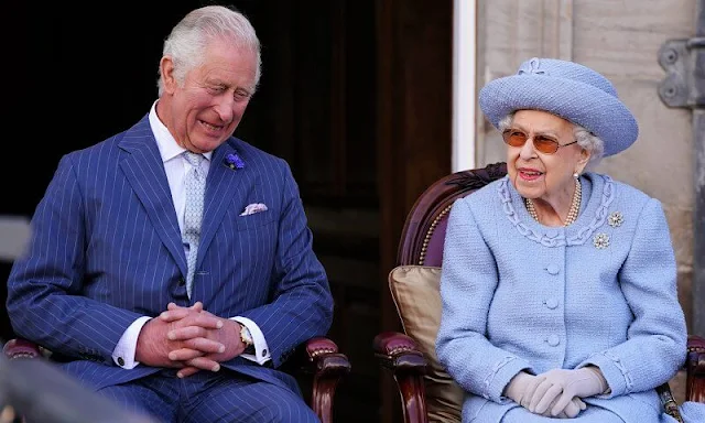 Queen Elizabeth wore a sky blue coat in the garden of the Palace of Holyroodhouse in Edinburgh