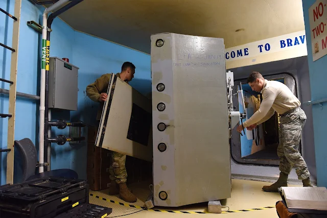 Image Attribute: Airmen service a reinforced door at a U.S. missile alert facility. The facilities would be upgraded or replaced as part of the Ground-Based Strategic Deterrent program. / Source: U.S. Air Force