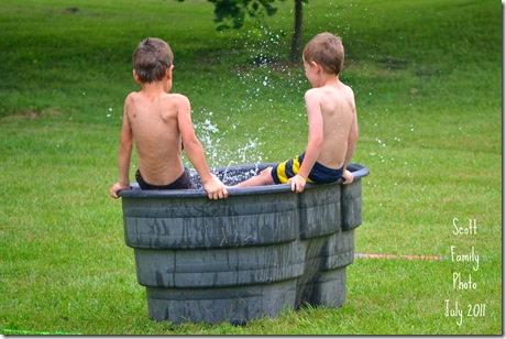 two kids in a stock tank