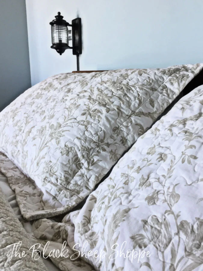 Neutral bedding works well with the blue colors in the room.