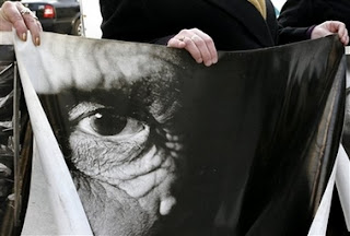 Relatives of Srebrenica victims hold photos relating to the massacre as they prepare to leave Sarajevo in Bosnia early Saturday, Feb. 24, 2007 for the Netherlands to attend Monday's verdict by the International Court of Justice in a genocide case against Serbia and Montenegro in the Hague. Bosnia-Herzegovina filed the case in 1993 — the first time a state, rather than individuals, had been charged with genocide. In case it wins, it hopes later to seek compensation for the loss of life and property during the 1992-95 war, when an estimated 200,000 people were killed and when entire Muslim Bosniak towns and villages were devastated.