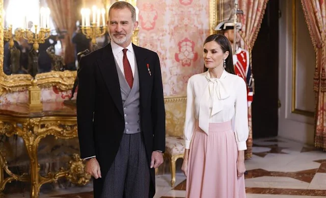 Queen Letizia wore a new pink maxi skirt by Carolina Herrera, and Bibosa silk bow blouse by Hugo Boss.