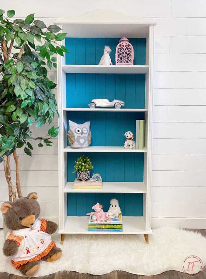 A small bookcase makeover for a baby nursery with mid-century modern style by replacing bun feet with vintage tapered wooden feet for a new look.