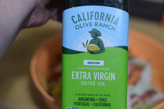 Extra virgin olive oil being added to the soy curl and pepper mixture.