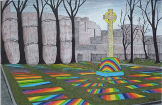 A cross stood amidst trees and rainbow reflections.