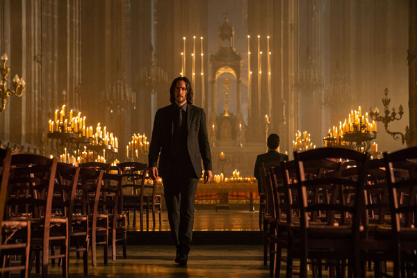 John Wick (Keanu Reeves) prepares to leave after conferring with his old friend and nemesis Caine (Donnie Yen) at a Paris church in JOHN WICK: CHAPTER 4.