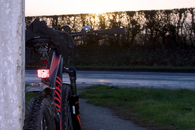 sunrise bike leaning against post