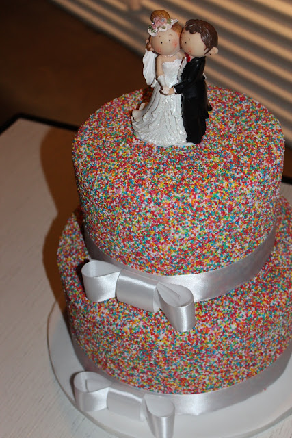 chocolate-mud-cake-covered-with-colorful-sugar-rice-and-silk-white-ribbon-design