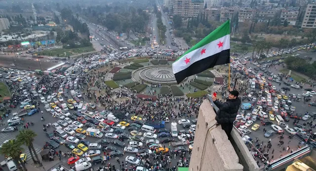 Cover Image Attribute: A Syrian man holding a Syrian opposition flag at the Ummayad Square, Damascus, Syria (Date 9 December 2024) / Source: Getty Images