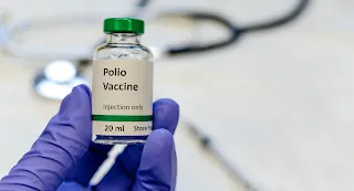 What is Polio? Discuss its symptoms, causes of spreading, prevention and vaccine.