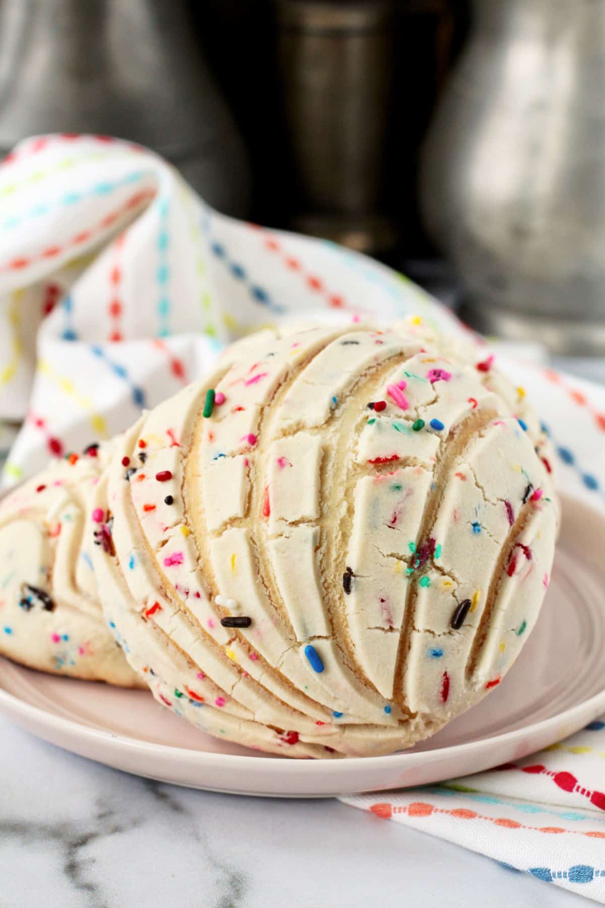 Funfetti Conchas on a pink plate.