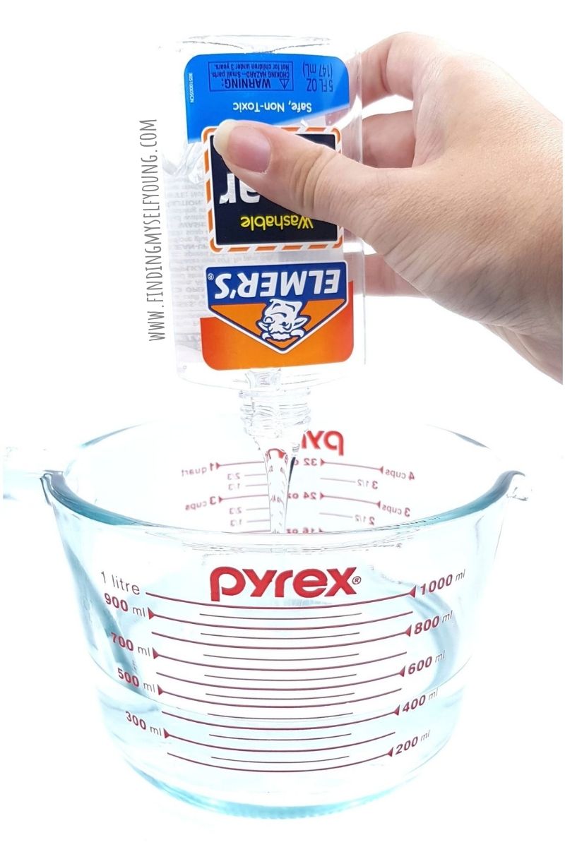 pouring elmers glue into jug of water