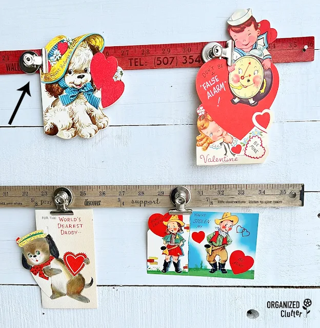 Photo of vintage Valentine's being displayed on old advertising yardsticks.