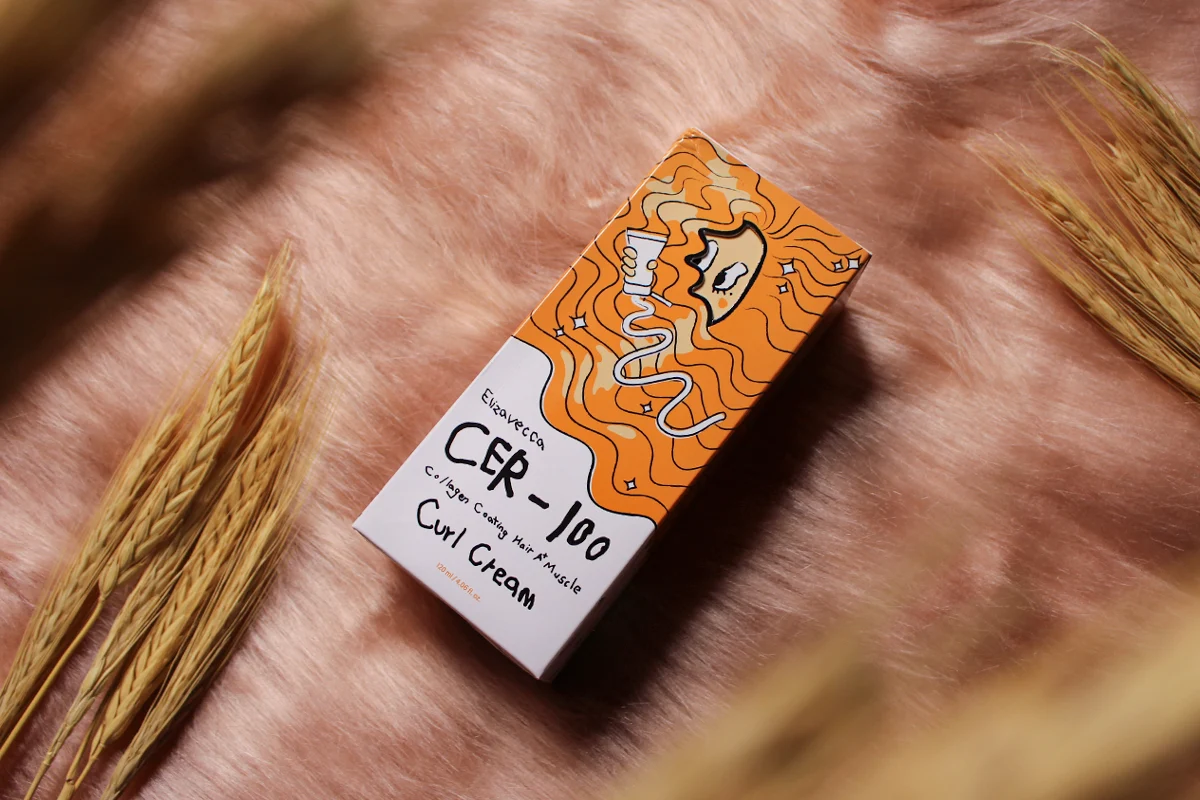 close-up aesthetic shot of a Elizavecca Cer-100 Collagen Coating Hair Curl Cream on top of a rose-gold furry rug