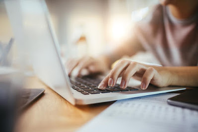 A lone small business owner working from a computer.