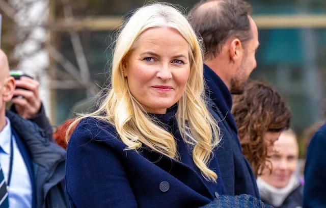 Crown Princess Mette-Marit wore a navy wool coat by Prada and navy pants and cashmere sweater