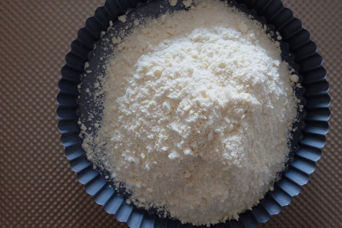 shortbread crust crumbs in pan to be formed