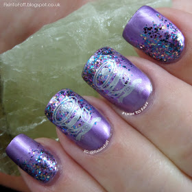 Metallic purple nails with a glitter gradient, topped with stamped silver bells.