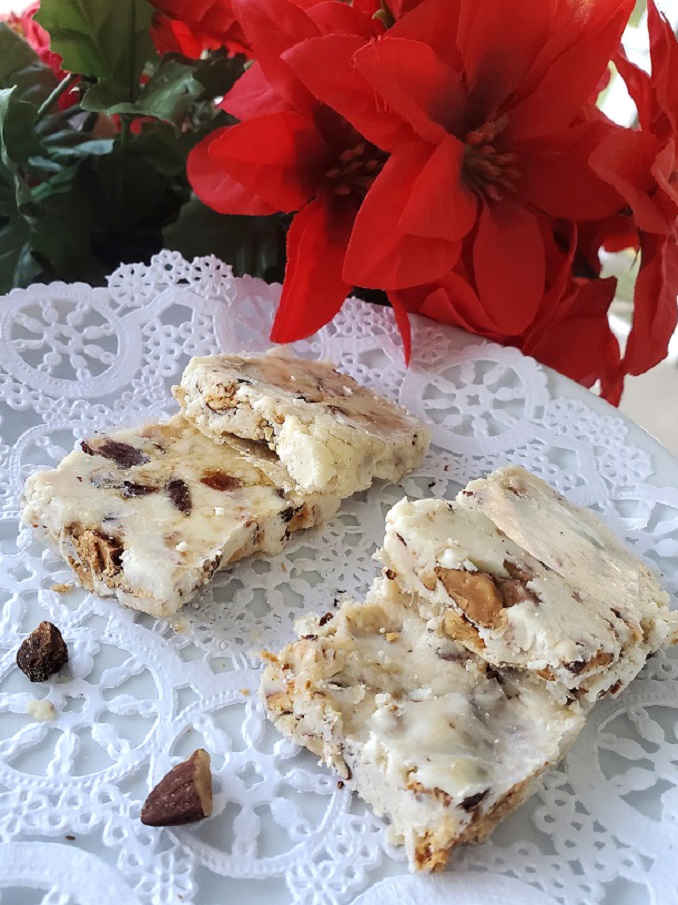 this torrone on a plate for christmas it has roasted almonds in a nougat style confection