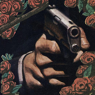 A caucasian hand aims a pistol at the viewer. The cuff of a black coat and white shirt are visible on the wrist. Roses and leaves surround the hand, this part in comic book art style..