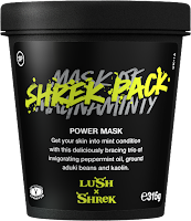 A photo of a black cylindrical tub with a black circular lid with mask of magnanimity in green font with Shrek pack written over the top in white font with face and body mask lush in white font on a bright background