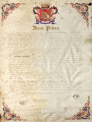 Carta de brasão de Augusto Leverger, barão de Melgaço e presidente do Mato Grosso, passada pelo rei de armas Manuel dos Santos Carramona e registrada pelo escrivão Luís Aleixo Boulanger em 1865. As suas armas são "em campo de goles um castelo de ouro, saindo pela porta uma [mão] destra ao natural, armada de uma espada de azul, posta em banda, acompanhado em chefe de uma estrela de prata entre as letras iniciais M–G de ouro e em ponta de um rio de prata, carregado de uma âncora de sable; divisa: SEMPRE PRONTO" (imagem disponível da Biblioteca Nacional Digital).