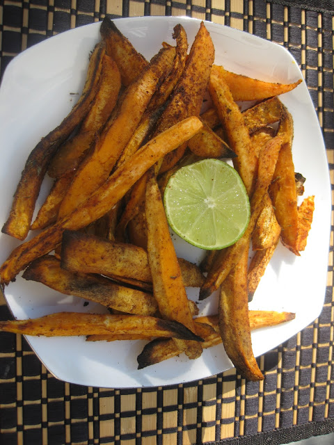 sweet potato fries on a plate with a lime