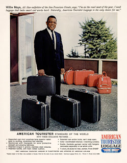 an American Tourister advertisement from 1966 featuring Willie Mays, a popular baseball player at the time holding and standing behind a set of black american tourister luggage. behind him sits a set of orange american tourister luggage