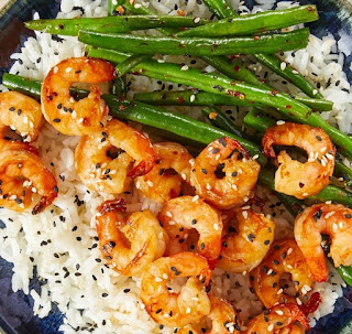 teriyaki shrimps in a plate with white rice and green beans